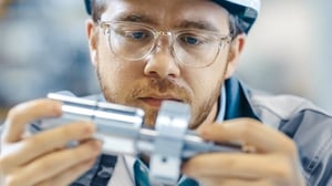 Man inspecting part that failed leak test.