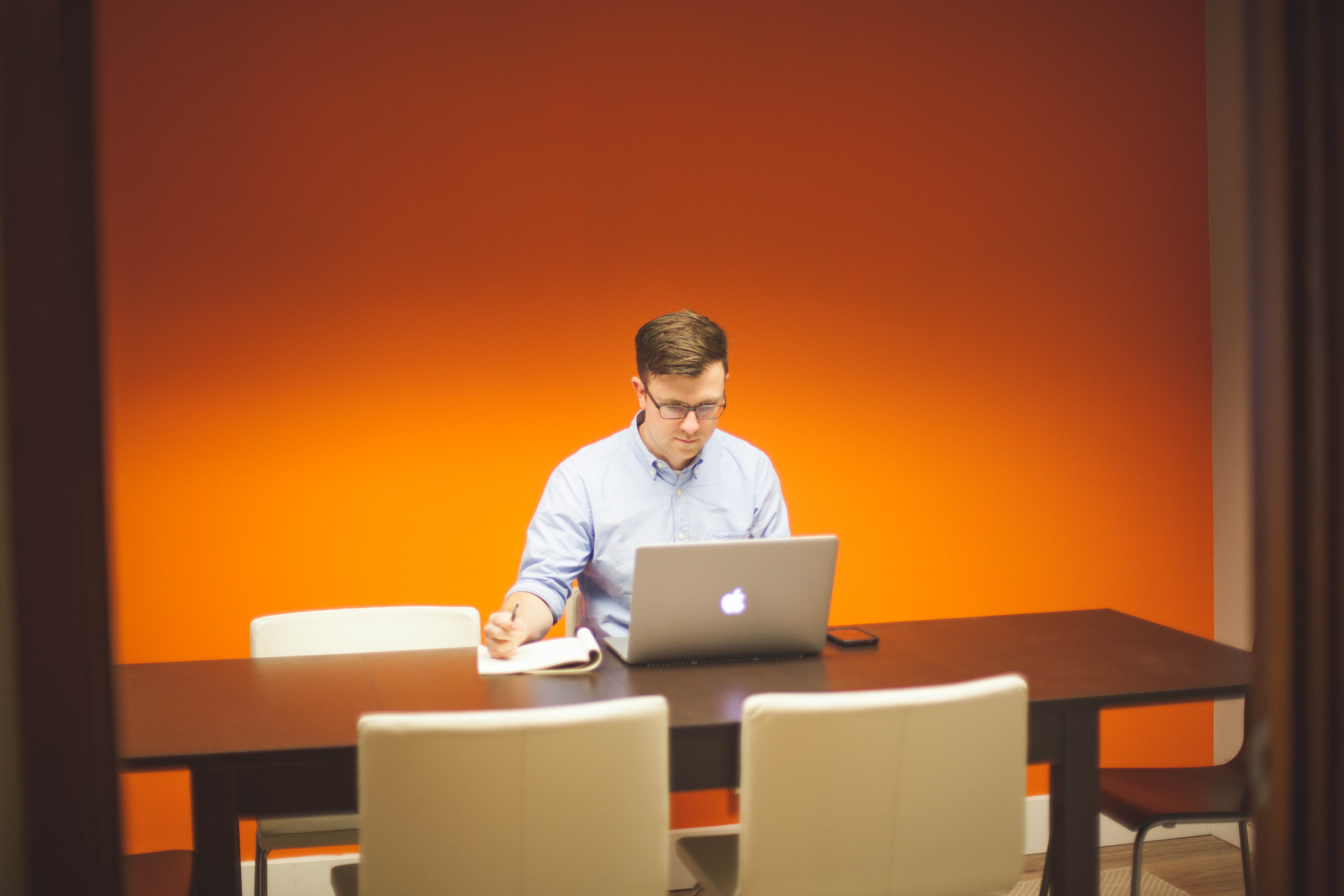 Employee taking notes from laptop Employee taking notes from laptop